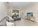 Bright living room with tile flooring and contemporary decor, next to the sliding glass door to outside at 701 Maraviya Blvd, Nokomis, FL 34275
