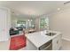 Bright, open living space adjacent to kitchen, features a large window, comfortable seating, and an elegant dining area at 701 Maraviya Blvd, Nokomis, FL 34275