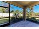 Relaxing screened in patio features brick flooring and a peaceful view of the private yard at 701 Maraviya Blvd, Nokomis, FL 34275