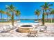 Relaxing pool area with stone fire pit and lounge chairs, perfect for socializing and enjoying the outdoors at 701 Maraviya Blvd, Nokomis, FL 34275
