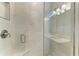 Detailed view of glass shower with tile surround, modern fixtures, and transom window at 701 Maraviya Blvd, Nokomis, FL 34275