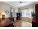 Bright bedroom with wood floors, fan and blue-and-white striped curtains at 7108 Playa Bella Dr, Bradenton, FL 34209