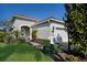 Charming single-story home with a well-manicured lawn and inviting front entrance at 7108 Playa Bella Dr, Bradenton, FL 34209
