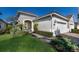 Beautiful single-story home featuring lush landscaping, manicured lawn and paver walkway at 7108 Playa Bella Dr, Bradenton, FL 34209