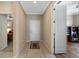 Neutral hallway with tile floor, view of bedroom, and access to study or office at 7108 Playa Bella Dr, Bradenton, FL 34209
