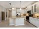 Bright kitchen with stainless steel appliances, granite counters, tile backsplash, and kitchen island at 7108 Playa Bella Dr, Bradenton, FL 34209