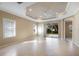 Spacious living room features tray ceiling, neutral walls, and a sliding glass door to the backyard at 7108 Playa Bella Dr, Bradenton, FL 34209