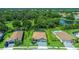 Aerial view of a home with screened in pool and lush surrounding landscape near a pond at 7323 Great Egret Blvd, Sarasota, FL 34241