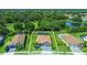 An aerial view of the home showcasing mature trees and a pool; this house includes a screened in lanai at 7323 Great Egret Blvd, Sarasota, FL 34241