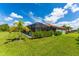 Exterior of the house with a screened in pool and lush green lawn at 7323 Great Egret Blvd, Sarasota, FL 34241