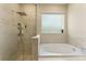 Well-lit bathroom featuring soaking tub, frameless glass shower and decorative tile at 7323 Great Egret Blvd, Sarasota, FL 34241