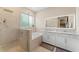 Modern bathroom featuring a double vanity, soaking tub, and frameless glass shower at 7323 Great Egret Blvd, Sarasota, FL 34241
