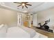 Spacious bedroom featuring a ceiling fan, wood floors, a Peloton and ensuite bathroom at 7323 Great Egret Blvd, Sarasota, FL 34241