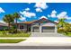 Well-manicured landscaping adds to the curb appeal of this charming home with a brick driveway and two-car garage at 7323 Great Egret Blvd, Sarasota, FL 34241