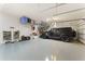 Spacious garage with epoxy flooring and organized storage, including overhead racks and wall-mounted systems at 7323 Great Egret Blvd, Sarasota, FL 34241