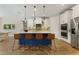 Bright kitchen with stainless steel appliances, a center island with seating, and modern pendant lighting at 7323 Great Egret Blvd, Sarasota, FL 34241