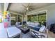 Inviting covered patio with comfortable seating, ceiling fan, and sliding glass doors for indoor-outdoor living at 7323 Great Egret Blvd, Sarasota, FL 34241
