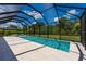 Gorgeous pool with large screened enclosure and travertine tile decking at 7323 Great Egret Blvd, Sarasota, FL 34241