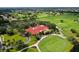 An aerial view showcases the lush golf course and beautiful clubhouse of this community at 7344 Villa D Este Dr, Sarasota, FL 34238