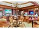Upscale bar area featuring a full bar with TVs, comfortable seating, and wood accents at 7344 Villa D Este Dr, Sarasota, FL 34238