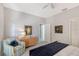 A comfortable bedroom with neutral decor, ceiling fan, and a cozy reading nook at 7344 Villa D Este Dr, Sarasota, FL 34238