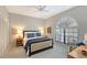 Bright bedroom with a large window, ceiling fan, and a comfortable reading chair at 7344 Villa D Este Dr, Sarasota, FL 34238