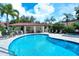 Gorgeous community pool with a covered pavilion and plenty of lounge chairs for residents at 7344 Villa D Este Dr, Sarasota, FL 34238