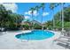Beautiful community pool area with palm trees, lounge chairs, and inviting blue water at 7344 Villa D Este Dr, Sarasota, FL 34238