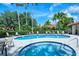Community pool area with a hot tub and plenty of seating for residents to relax and enjoy at 7344 Villa D Este Dr, Sarasota, FL 34238