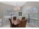 Bright dining area with a wooden table, seating for four, and arched windows at 7344 Villa D Este Dr, Sarasota, FL 34238