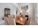 Bright dining room featuring high ceilings, a modern light fixture, and a beautiful wood table at 7344 Villa D Este Dr, Sarasota, FL 34238