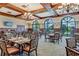 The elegant dining room boasts floor-to-ceiling windows, decorative chandeliers, and comfortable seating at 7344 Villa D Este Dr, Sarasota, FL 34238