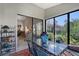 Bright dining area with seating for six, glass-top table, and large sliding doors to outside space at 7344 Villa D Este Dr, Sarasota, FL 34238