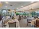 Elegant dining room featuring chandeliers, ample seating and beautiful views of outdoor area at 7344 Villa D Este Dr, Sarasota, FL 34238