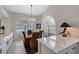 Bright dining area with a wooden table, seating for four, and arched windows at 7344 Villa D Este Dr, Sarasota, FL 34238