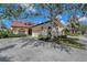 A beautiful single-story home has a well-manicured yard, elegant arched windows, and a two-car garage at 7344 Villa D Este Dr, Sarasota, FL 34238