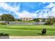 Scenic view of golf course and lake with residential buildings in the distance on a clear day at 7344 Villa D Este Dr, Sarasota, FL 34238
