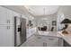 Modern white kitchen featuring stainless steel appliances, marble countertops, and an island at 7344 Villa D Este Dr # 7344, Sarasota, FL 34238