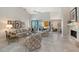 Well-lit living room featuring a fireplace, high ceilings, tile floors and sliding glass doors to a patio at 7344 Villa D Este Dr, Sarasota, FL 34238