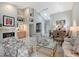 Open-concept living room features a fireplace, wet bar, and views of the dining area at 7344 Villa D Este Dr, Sarasota, FL 34238