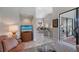 Open living space connecting to the dining room with beautiful tile flooring, high ceiling, and glass doors at 7344 Villa D Este Dr, Sarasota, FL 34238
