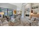 Spacious living room featuring a fireplace, wet bar, comfortable seating and a view to the patio at 7344 Villa D Este Dr, Sarasota, FL 34238