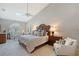 Spacious main bedroom with a skylight, sitting area, and stylish decor at 7344 Villa D Este Dr, Sarasota, FL 34238