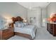 Spacious main bedroom boasts a decorative headboard, ceiling fan and ensuite bathroom at 7344 Villa D Este Dr, Sarasota, FL 34238