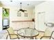 Pool cabana with ceiling fan, table, chairs, kitchenette, and a view of the pool at 7344 Villa D Este Dr, Sarasota, FL 34238