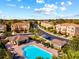 Aerial view of community pool, cabanas, and neighborhood landscaping at 8811 White Sage Loop # 8811, Lakewood Ranch, FL 34202