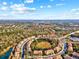 Beautiful aerial view of a community featuring lush greenery and a sparkling lake in a desirable location at 8811 White Sage Loop # 8811, Lakewood Ranch, FL 34202