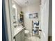 Well-lit bathroom features decorative coastal décor and a bright, clean aesthetic at 8811 White Sage Loop # 8811, Lakewood Ranch, FL 34202