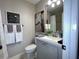 Bathroom featuring modern fixtures, a large mirror, and fresh towels at 8811 White Sage Loop # 8811, Lakewood Ranch, FL 34202