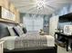 This bedroom features a queen bed, modern light fixture, and accent wall at 8811 White Sage Loop # 8811, Lakewood Ranch, FL 34202